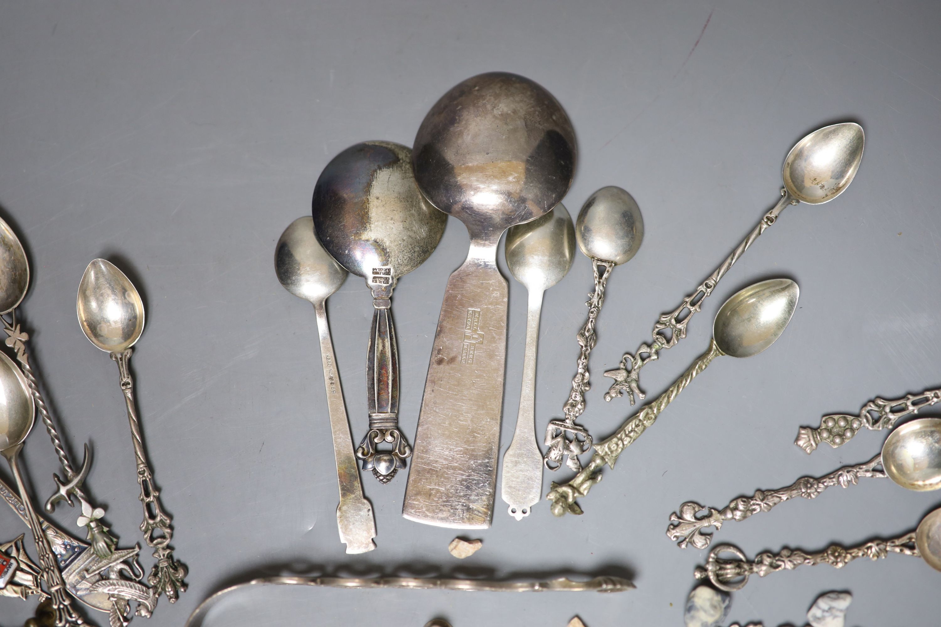 A Georg Jensen & Wendel A/S sterling small spoon, 10.2cm, a pair of antique silver sugar tongs(a.f.), a metal snuff box and a small group of minor spoons including continental white metal.